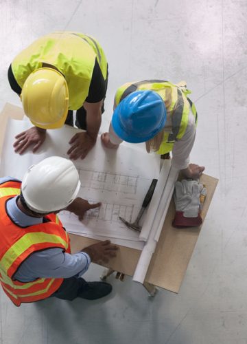 Engineers looking at blueprints
